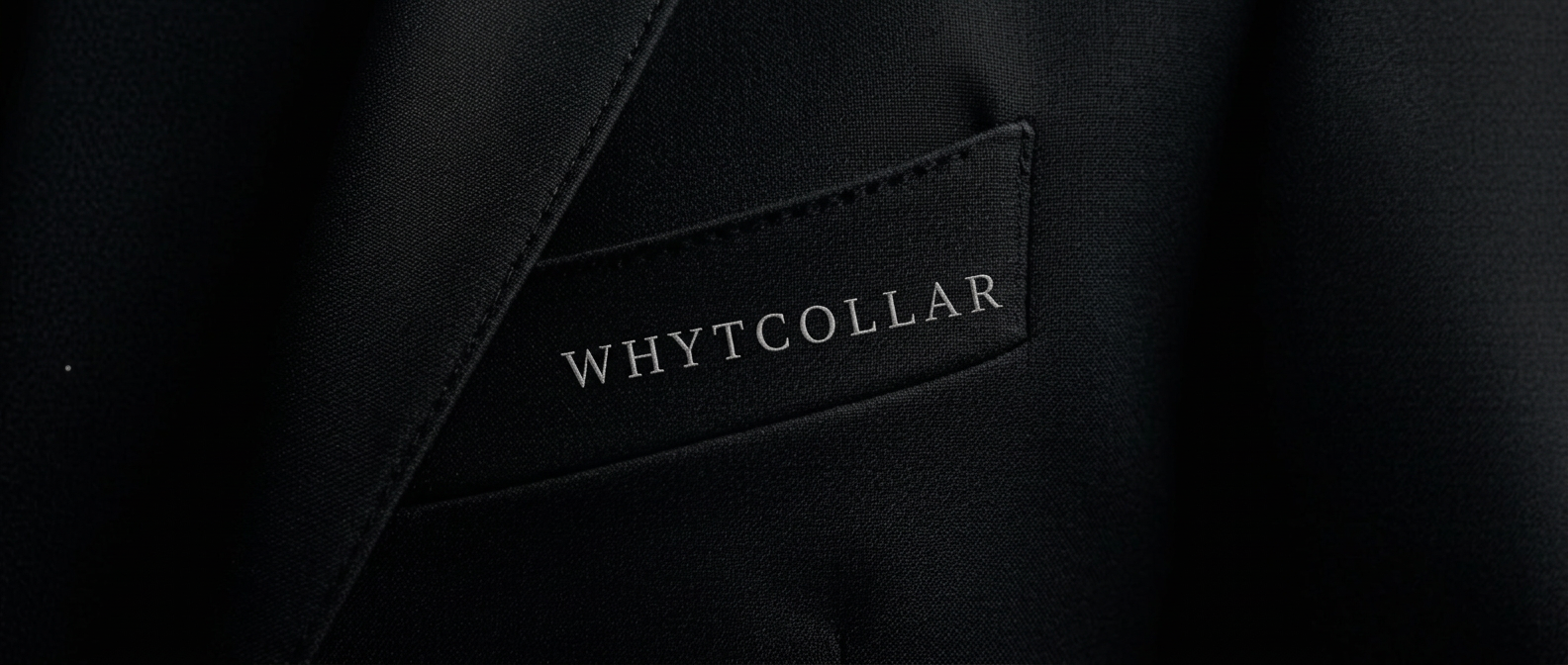 WHYTCOLLAR wordmark, embroidered into the chest of an Obsidian blazer